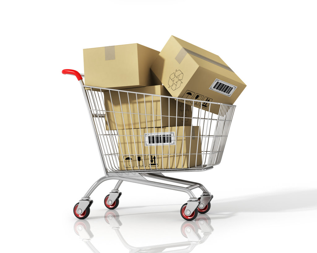 Shopping cart with boxes on white isolated background.